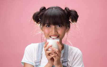 Young pretty woman drinking milk, health nutritionの写真素材