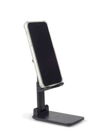 Smartphone with blank screen on black plastic holder isolated on white backgroundの写真素材