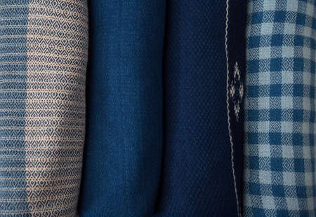 Roll of hand woven shawls, Thai cotton indigo dyed isolated on white backgroundの写真素材