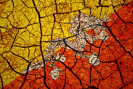 Dry soil pattern on the flag of Bhutan. Country with drought concept. water problem. Dry cracked earth country.の写真素材