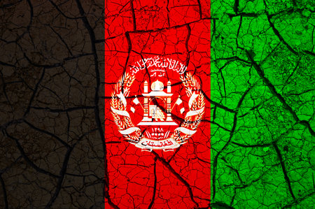 Dry soil pattern on the flag of Afghanistan. Country with drought concept. water problem. Dry cracked earth country.の写真素材