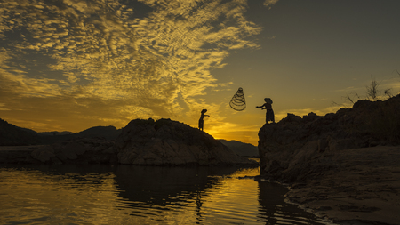 Asian boy fishing in the river .