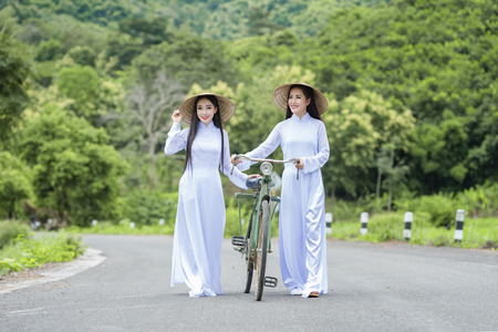 Portrait of VIetnam girl with Ao Dai at cornfield, Vietnam traditional dress,Ao dai is famous traditional costume for woman in VIetnam.の写真素材