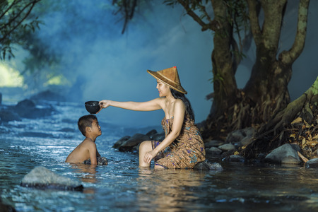 Women and children were playing in the water stream .の写真素材