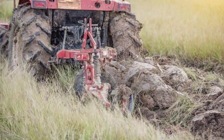 Agriculture,tractor preparing land with seedbed cultivator as part of pre seeding activities in early spring season of agricultural works at farmlands.の写真素材