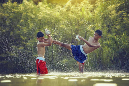 The fighter tying tape around his hand preparing to fight,Thai boxing at the river,boxing and fighting to protect.の写真素材