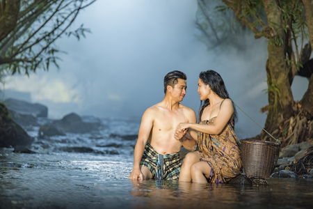 Happy Smiling Couple in love,and the couple was bathing brook.の写真素材