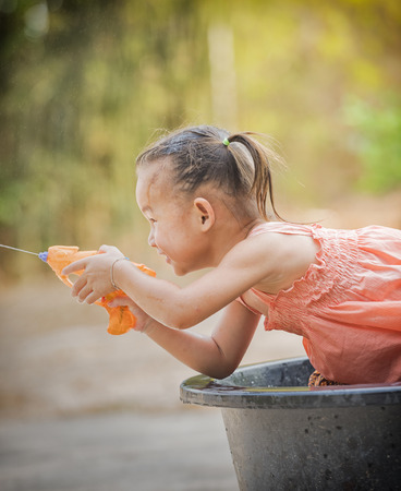 Happy little girl playing with water.の写真素材
