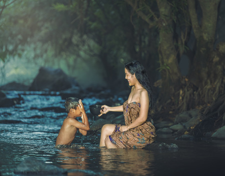 Women and children were playing in the water stream .の写真素材