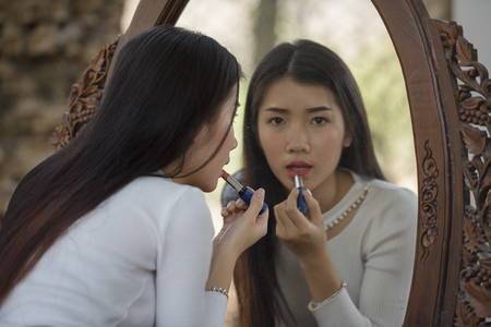 Makeup artist applies eyeshadow. Beautiful woman face. Perfect makeupの写真素材