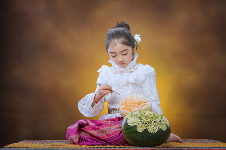 Fruits Carving,fruit carved shape beautiful flower,happy Asian girl smile and laugh together,Little girl smiling  with retro background,Thailand Artsの写真素材