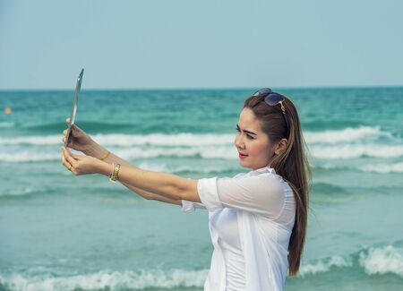 Selfie girl at the beach.の写真素材
