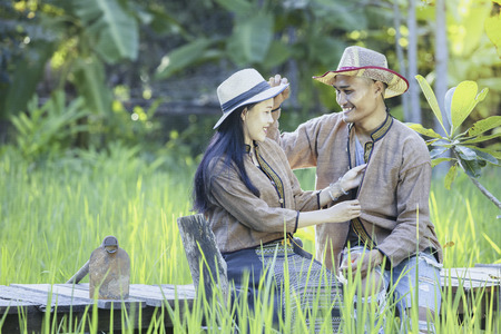 Farmers in Asia take care of the rice quality in the field as well as harvest the produce.の写真素材