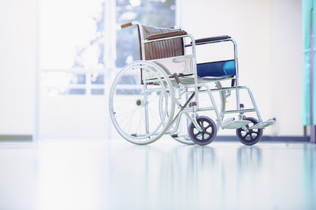 Wheelchairs in the hospital,patient is sitting in a wheelchair,He holds his hands on the wheel,Self-care patients with mobility.の写真素材