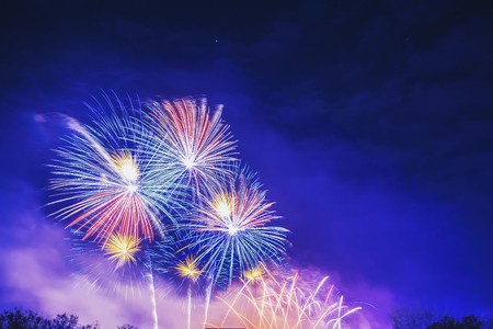 Brightly Colorful Fireworks on twilight background.Abstract colored firework background with free space for text.Colorful firework with copy space for New Year celebration, Abstract holiday background.の写真素材