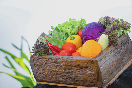 Fresh organic vegetables. Food background. Healthy food from garden. Adult Farmer Holding Fresh Local Vegetable.Vegetables on wooden background. Bio healthy organic food, herbs and spices.の写真素材