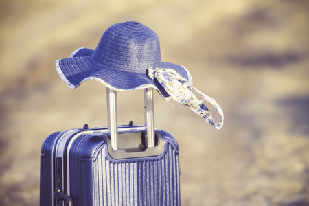 Tourist planning vacation with the help of world map with other travel accessories around.Suitcase and hat with background sunset.Travel concept nature of things ready to be taken on holiday.の写真素材