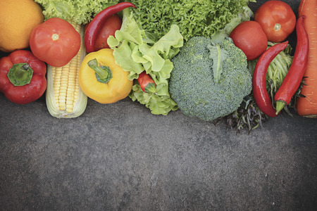 Fresh organic vegetables. Food background. Healthy food from garden. Adult Farmer Holding Fresh Local Vegetable.Vegetables on wooden background. Bio healthy organic food, herbs and spices.の写真素材