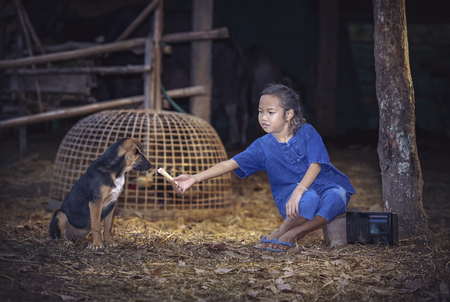 Rural happy family.Cute girl having fun at the field. Family in Countryside.の写真素材