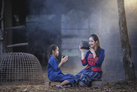 Rural happy family.Cute girl having fun at the field. Family in Countryside.