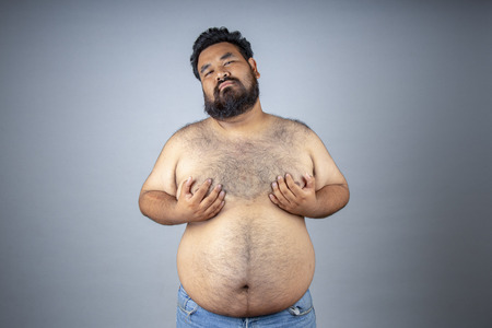 Fat men on a white background. Fat man with a big belly. Fat man eat a lot of food, extra weight,...