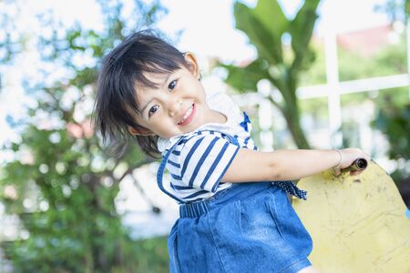 Cute little Asian girl is enjoying the player on the playground. Little girl playing at the playground.の写真素材
