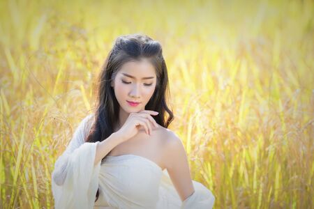 Beautiful Asian women with natural beauty. Beautiful woman with rice in nature for beauty cosmetic products. Beauty Spa Woman with perfect skin Portrait.の写真素材