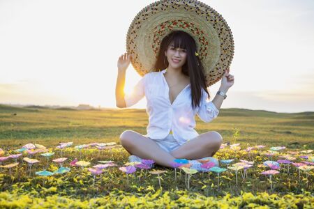 Happy  woman relaxing in summer sunset sky. Freestyle Happy Woman Enjoying Nature. People freedom style. Enjoyment.の写真素材