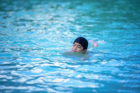 Children learn to swim in the swimming pool for exercise. Activities on the pool, Children swimming and playing in water.の写真素材