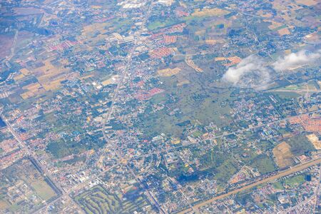 Aerial view of mountains, rivers, clouds, Agricultural Landscape areas the green and yellow rice field, Aerial view of grew in different pattern, And housing.Remote viewing.の写真素材