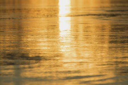 Sunset in the evening, Orange sea water.The beauty of the water at sunset, The sun hits the water is golden.の写真素材
