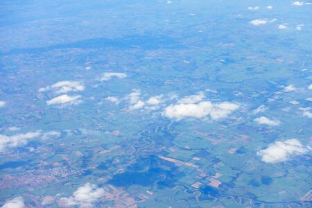 Aerial view of mountains, rivers, clouds, Agricultural Landscape areas the green and yellow rice field, Aerial view of grew in different pattern, And housing.Remote viewing.の写真素材