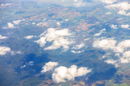 Aerial view of mountains, rivers, clouds, Agricultural Landscape areas the green and yellow rice field, Aerial view of grew in different pattern, And housing.Remote viewing.の写真素材
