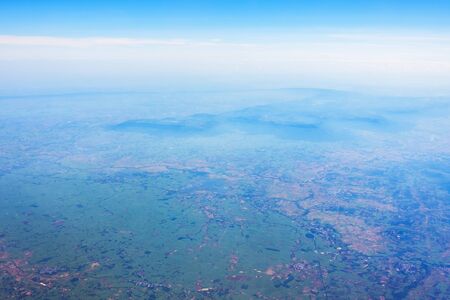 Aerial view of mountains, rivers, clouds, Agricultural Landscape areas the green and yellow rice field, Aerial view of grew in different pattern, And housing.Remote viewing.の写真素材