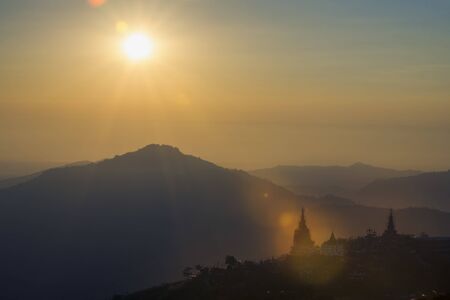 Sunrise and fog on the mountain. Sunlight with the sun's rays illuminate the beautiful mountain.の写真素材