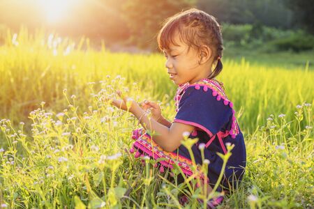 Hmong tribe, Happy Asian little girl from Hmong tribe. Asian little child smiling with the field at the hill.の写真素材