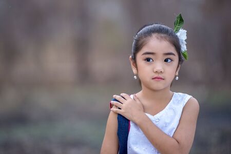 Happy Asian little girl in a traditional dress, Little girl in traditional Lanna costumes in Chiang Mai, Thailand.の写真素材