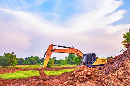 Backhoe, View of the backhoe was digging a pit in the ground. Large tracked excavator works in dig a pond. Backhoe excavator on construction site. の写真素材