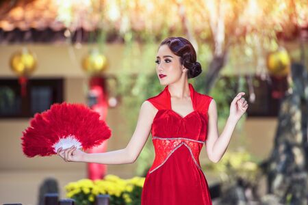Chinese dress,Asian woman in chinese dress traditional cheongsam. Beauty woman wear Cheongsam  in chinese new year.の写真素材