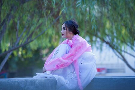 Korean girl in traditional dress, Beautiful Asian girl in traditional Korean dress,Hanbokの写真素材