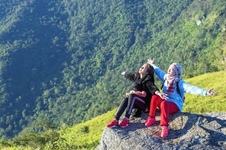 Freedom traveler enjoying a beautiful nature, Lifestyle concept. Young traveler on the top of mountain and enjoy the beauty of view. Young girl love wild life, travel, freedom..の写真素材