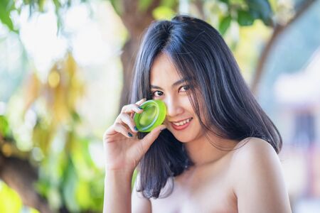 Beautiful women bath using soap that contains natural ingredients.Young woman using bar of natural soap.の写真素材