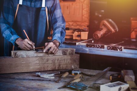 Carpenter cut wood to transform to make furniture. Carpentry works on woodworking machinery in carpentry.の写真素材
