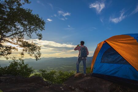 Tourists pitch a tent on the cliff to see the beauty of the sunrise and sunset.の写真素材