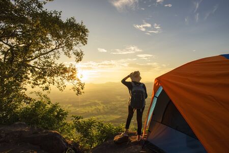 Tourists pitch a tent on the cliff to see the beauty of the sunrise and sunset.の写真素材