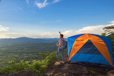 Tourists pitch a tent on the cliff to see the beauty of the sunrise and sunset.の写真素材