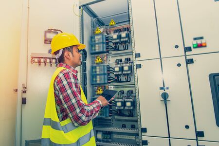 Control cabinet ,Control Room Engineer. Power Plant Control Panel. Engineer standing in front of the control panel in the control room.の写真素材