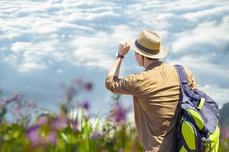 Travelers and traveling to nature. Hipster young travelers with backpack enjoying nature of mountain. Adventurer hiker looking beautiful nature.の写真素材