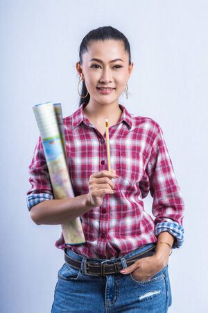 Beautiful young working women grinning professional in office confident expression. A confident young woman is checking the job. Have the opportunity to work everywhere.の写真素材