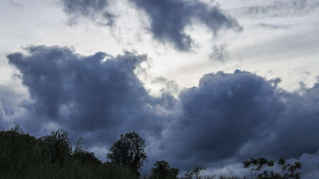 Rain clouds background.Clouds become dark gray like a big smoke before rainfall. Dark dramatic sky with a stormy gray clouds just before storm. The rain is coming soon.の写真素材